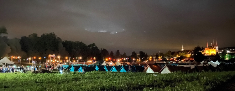 beleuchtete Zelte von JUBLA-Scharen auf Wiese bei Nacht